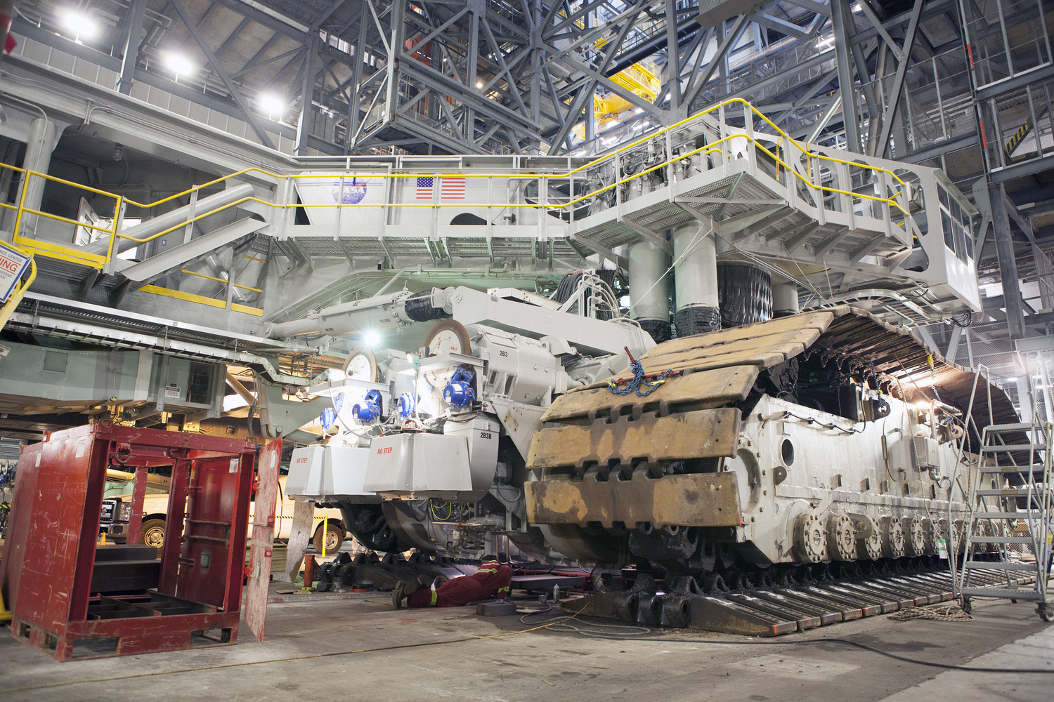 Inside the Vehicle Assembly Building at NASA’s Kennedy Space Center in Florida, the B and D truck sections of crawler-transporter 2, or CT-2, are being raised up to prepare for installation of new roller bearing assemblies. Work continues in high bay 2 to upgrade CT-2. The modifications are designed to ensure CT-2’s ability to transport launch vehicles currently in development, such as the agency’s Space Launch System, to the launch pad. Photo Credit: NASA / Dimitri Gerondidakis