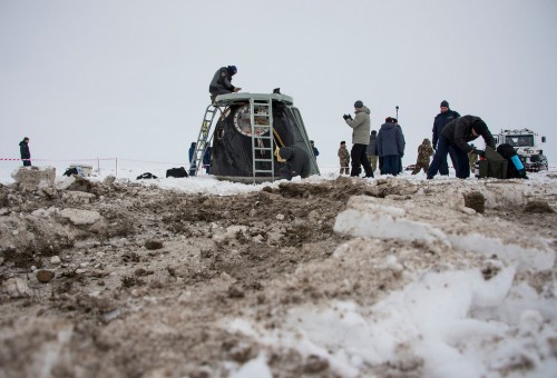 Recovery forces work outside the Soyuz TMA-10M descent module, shortly after touchdown. Photo Credit: NASA