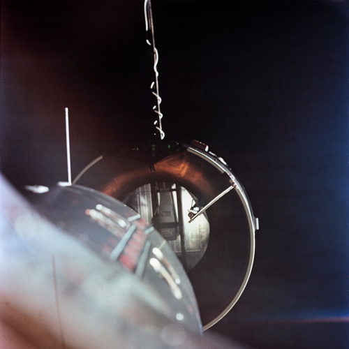 Gemini VIII's nose edges into the docking collar of the Agena target. Although this mission achieved a successful rendezvous and docking, it fell victim to violent oscillations, due to a stuck-on thruster, which almost cost Neil Armstrong and Dave Scott their lives. Photo Credit: NASA
