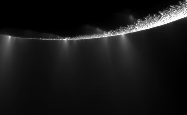 The water vapour plumes of Enceladus, erupting from deep fissures in the surface at the moon's south pole. Photo Credit: NASA / JPL-Caltech