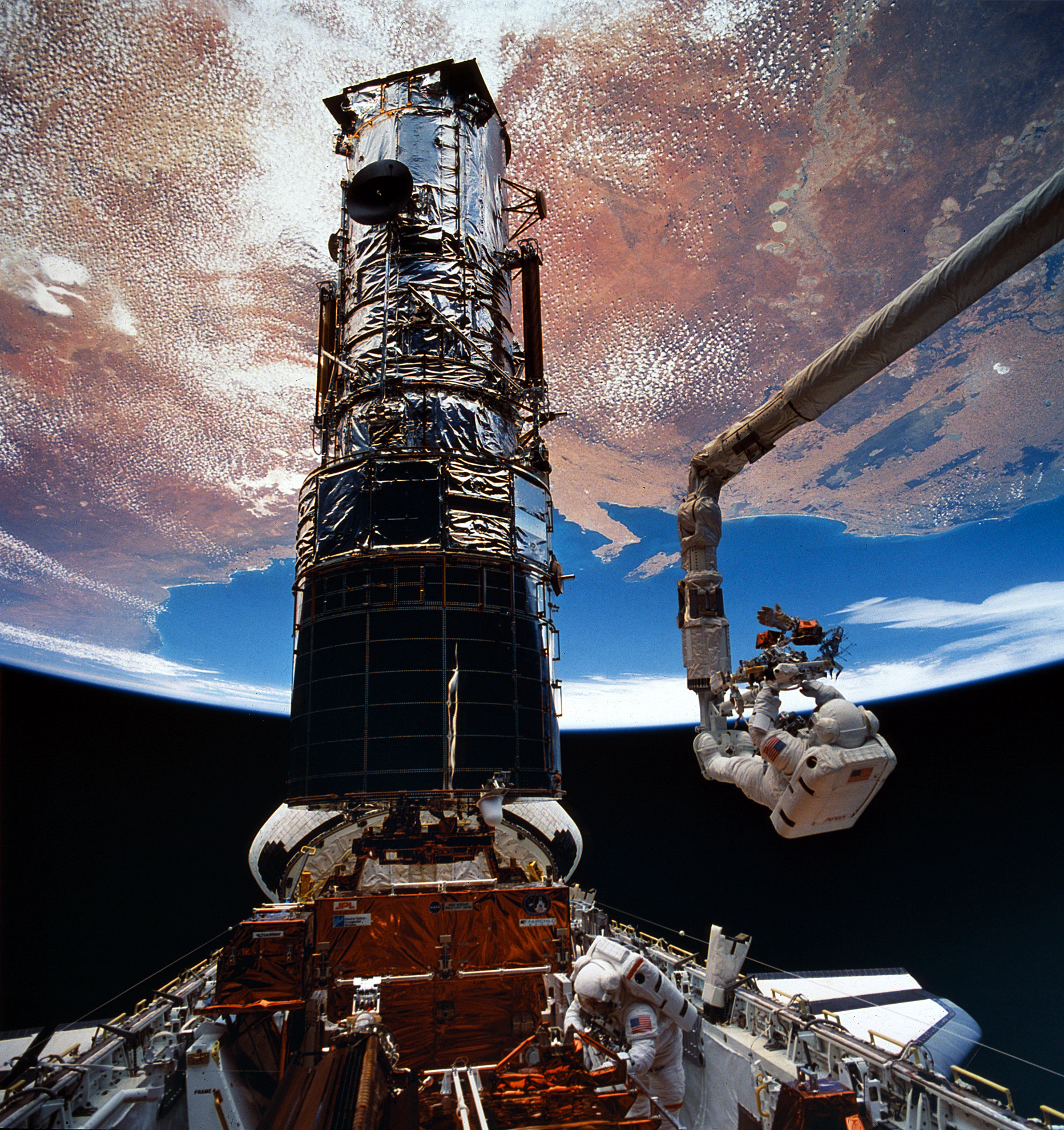 Astronaut Story Musgrave is positioned to replace components at the end of Endeavour's Remote Manipulator System (RMS) mechanical arm on STS-61 in December 1993. Photo Credit: NASA