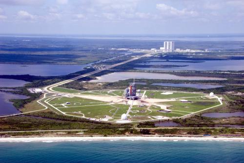 An aerial view of pad 39A occupied by space shuttle Endeavour for STS-118, with the iconic Vehicle Assembly Building easily visible a few miles away. Photo Credit: NASA