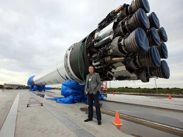 SpaceX CEO Elon Musk with one of his company's Falcon-9 rockets. Photo Credit: SpaceX