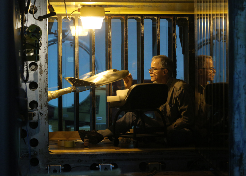 NASA technician Ricky Hall prepares a scale model of Sierra Nevada Corporation's Dream Chaser spacecraft for tests inside the Unitary Plan wind tunnel at NASA's Langley Research Center in Hampton, Virginia. Photo Credit: NASA/David C. Bowman