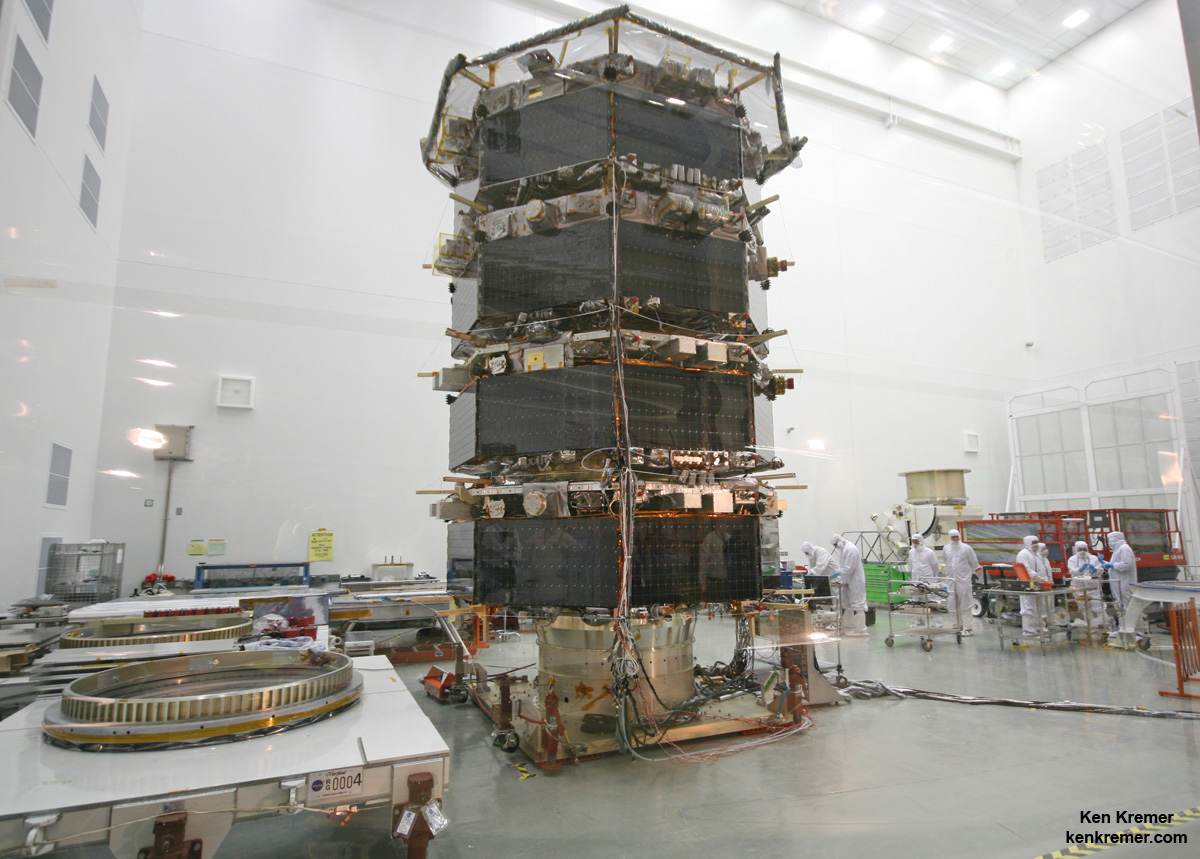 Technicians work on NASA’s 20-foot-tall Magnetospheric Multiscale (MMS) mated quartet of stacked observatories in the cleanroom at NASA's Goddard Space Flight Center in Greenbelt, Md., on May 12, 2014.  Credit: Ken Kremer- kenkremer.com