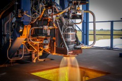 An advanced 3D printed SuperDraco engine, the same which will fly on the piloted Dragon spacecraft, conducting qualification testing at the company's Rocket Development Facility in McGregor, Texas last month. Photo Credit: SpaceX