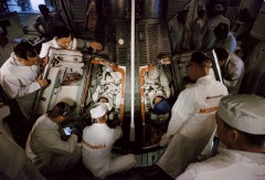 Assisted into the Gemini IV spacecraft by McDonnell technicians, this view shows the smallness of the place that Jim McDivitt and Ed White called "home" for four days in June 1965. Photo Credit: NASA