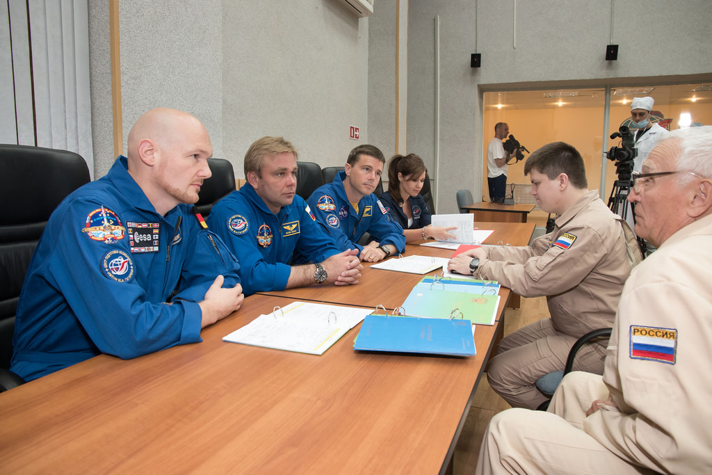 Pictured at the Cosmonaut Hotel at Baikonur last week, the Soyuz TMA-13M crew of (left to right) Alexander Gerst, Maksim Surayev and Reid Wiseman review flight procedures, ahead of their six-month voyage. Photo Credit: NASA