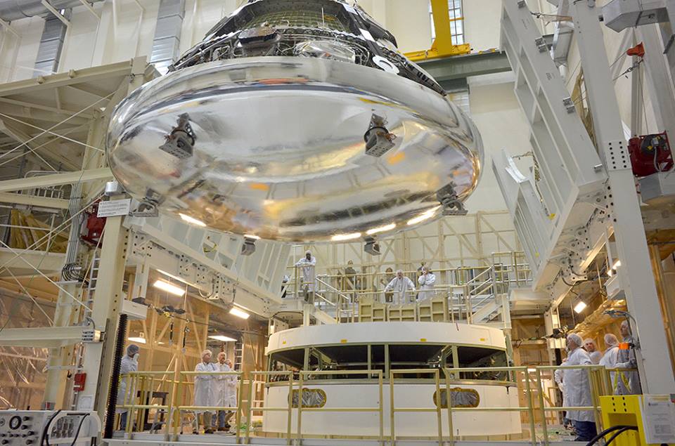Orion, seen here with its heat shield installed, being maneuvered for stacking on the spacecraft's service module at KSC earlier this month. Photo Credit: NASA 