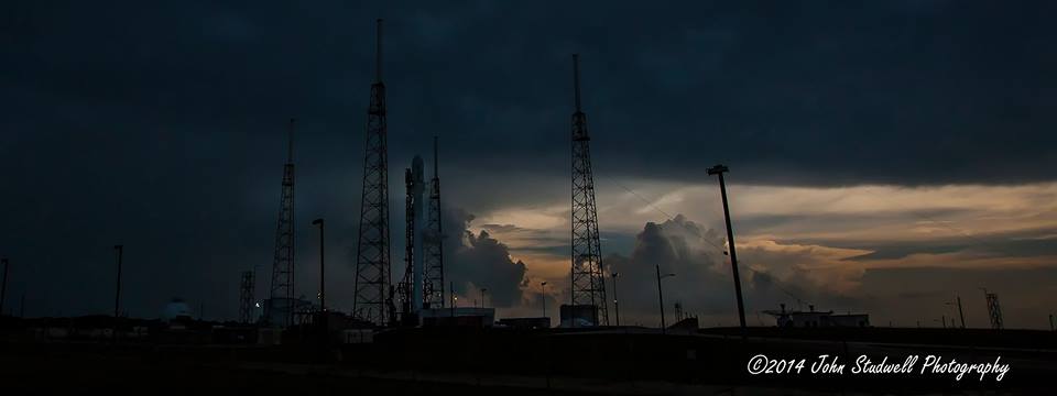 The SpaceX Falcon-9 v1.1 rocket with its OG2 payload waiting out the storms, which eventually scrubbed the company's second launch attempt. Photo Credit: AmericaSpace / John Studwell