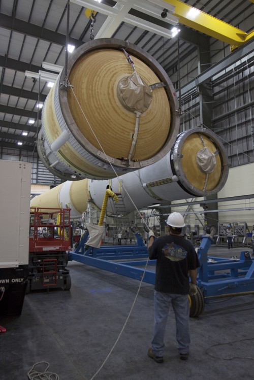 The upper stage of the ULA Delta-IV Heavy rocket for Orion's EFT-mission is seen here next to the rocket's port booster inside the Horizontal Integration Facility, or HIF, at Space Launch Complex 37 on Cape Canaveral Air Force Station in Florida. Photo Credit: NASA