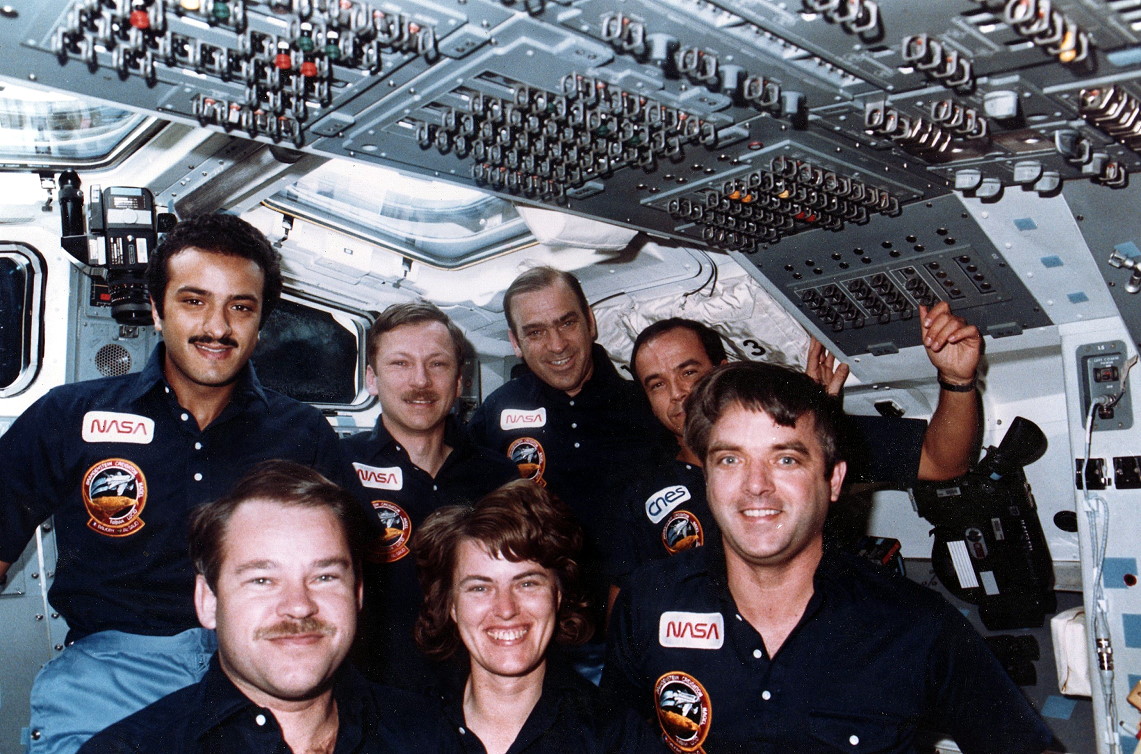 Pictured on Discovery's aft flight deck, the STS-51G crew featured three discrete sovereign nations for the first time in shuttle history. Front row, from left, are John Creighton, Shannon Lucid and Dan Brandenstein, with Sultan Abdul-Aziz Al-Saud, Steve Nagel, John Fabian and Patrick Baudry in the background. Photo Credit: Joachim Becker/SpaceFacts.de