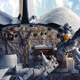 Dave Leestma (left) and Kathy Sullivan at work in Challenger's payload bay during Mission 41G in October 1984. Photo Credit: NASA