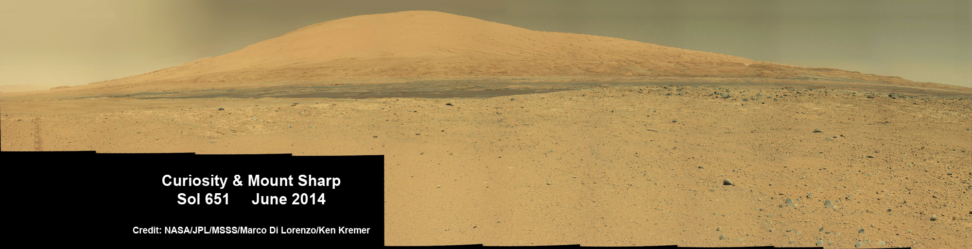 Curiosity rover panorama of Mount Sharp captured on June 6, 2014 (Sol 651) during traverse inside Gale Crater. Note rover wheel tracks at left. She will eventually ascend the mountain at the ‘Murray Buttes’ at right later this year. Assembled from Mastcam color camera raw images and stitched by Marco Di Lorenzo and Ken Kremer. Credit: NASA/JPL/MSSS/Marco Di Lorenzo/Ken Kremer-kenkremer.com