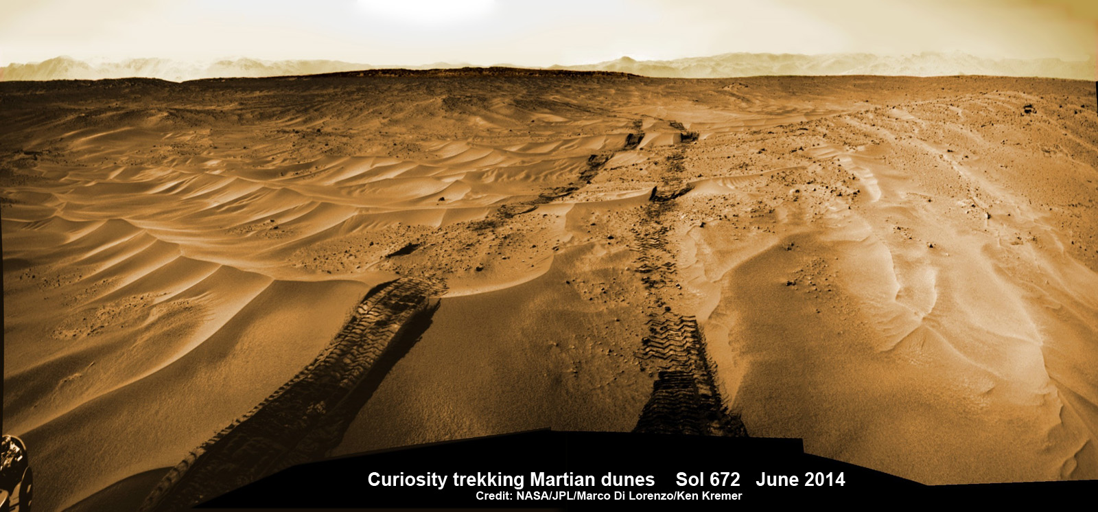 Curiosity treks across Martian dunes and drives outside landing ellipse here, in this photo mosaic view captured on Sol 672, June 27, 2014. Distant eroded rim of Gale Crater seen in background. Navcam camera raw images stitched and colorized. Credit: NASA/JPL-Caltech/Marco Di Lorenzo/Ken Kremer – kenkremer.com