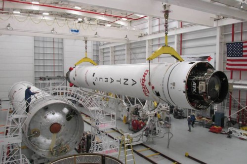 The Antares vehicle for the ORB-2 mission lifted onto the Transporter-Erector-Launcher (TEL). The first stage core for the next mission (ORB-3) is on the left. Photo Credit: Orbital Sciences