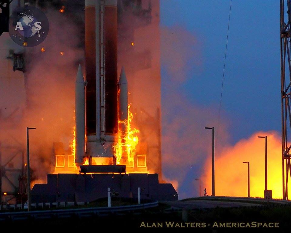 Literally blackened by the initial inferno of engine ignition, the Delta IV builds up thrust, ahead of liftoff. Photo Credit: Alan Walters/AmericaSpace