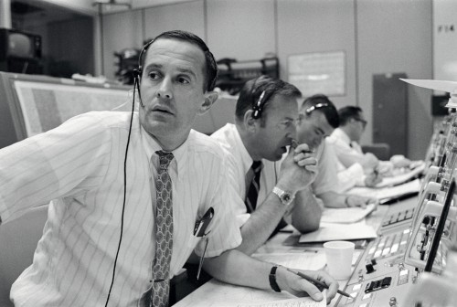 Pictured at their consoles during the landing operation (foreground to background) are Capcom Charlie Duke and Apollo 11 backup commander Jim Lovell and backup lunar module pilot Fred Haise. Photo Credit: NASA