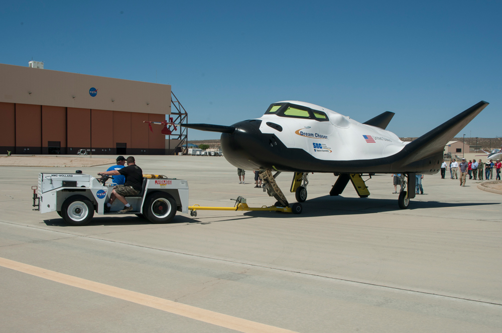 Sierra Nevada Corporation's Dream Chaser engineering test vehicle is towed across the ramp at NASA's Dryden Flight Research Center in preparation for tow tests on a Dryden taxiway. The tow tests were part of ground tests in preparation for captive-carry and free-flight tests last year at NASA Dryden. Photo Credit: NASA / Ken Ulbrich