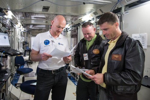 Barry "Butch" Wilmore (center) works with Expedition 41 crewmates Alexander Gerst (left) and Reid Wiseman in the Space Station Training Facility (SSPF) at the Johnson Space Center (JSC) in Houston, Texas. Photo Credit: NASA