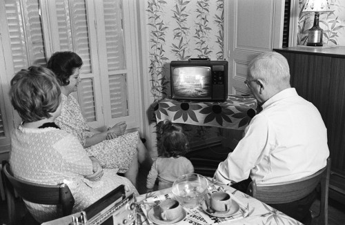 A family in Paris watches Neil Armstrong and Buzz Aldrin take their first steps on the Moon, live on TV, in 20 July 1969. Image Credit: AFP/Getty Images. 