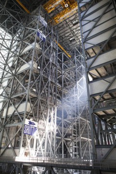From NASA: "Steel structures surround High Bay 3 inside the Vehicle Assembly Building, or VAB, at NASA’s Kennedy Space Center in Florida. In view, high above, is the 175-ton crane. Banners note the heights of the Saturn V, Space Launch System, or SLS, and shuttle on the steel structure." Photo Credit: NASA/Dimitri Gerondidakis