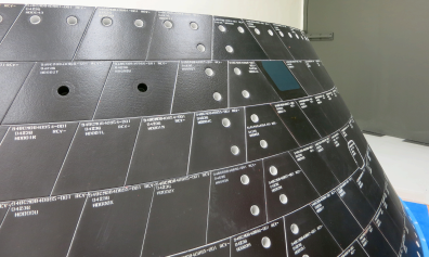 Two one-inch-wide holes have been drilled into tiles on Orion’s back shell to simulate micrometeoroid orbital debris damage. Photo Credit: NASA