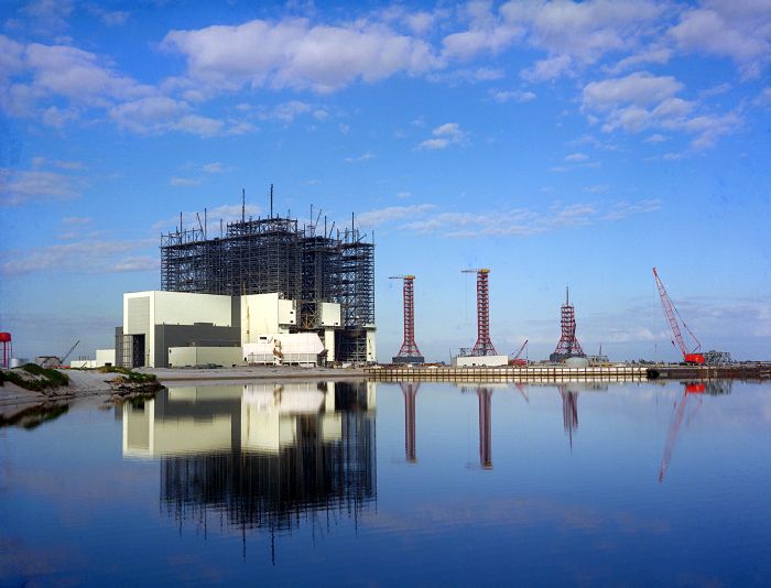 From NASA: "VAB during construction (1965) with the Mobile Launcher Platform and tower assemblies for the Saturn V rocket." Photo Credit: NASA