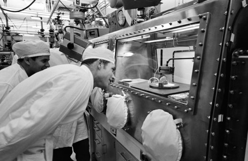 Dave Scott peers at the Genesis Rock in the laboratory, after the mission. Photo Credit: NASA