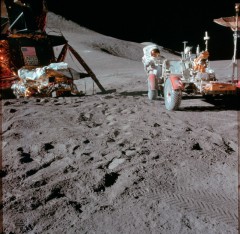 Jim Irwin works with the lunar rover, close to the lunar module Falcon. Photo Credit: NASA