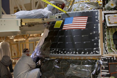 Engineers install Orion's protective back shell for its upcoming EFT-1 mission next Dec. Photo Credit: NASA