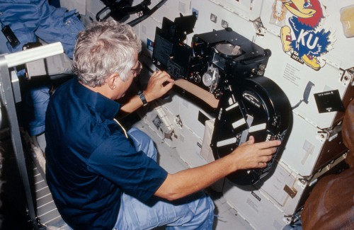 Hank Hartsfield works with the IMAX camera on Discovery's middeck. Photo Credit: NASA