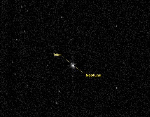 New Horizons captured this view of Neptune and its large moon Triton on July 10, 2014 from a distance of about 2.45 billion miles (3.96 billion kilometers) - more than 26 times the distance between the Earth and Sun. The 967-millisecond exposure was taken with the onboard telescopic Long-Range Reconnaissance Imager (LORRI). Image Credit: NASA/Johns Hopkins University Applied Physics Laboratory/Southwest Research Institute