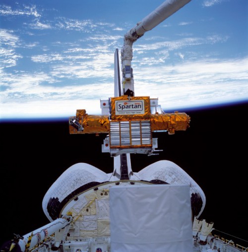 Susan Helms maneuvers SPARTAN-201 into its deploy position. The white cylinder of the LITE payload is visible in the foreground. Photo Credit: NASA