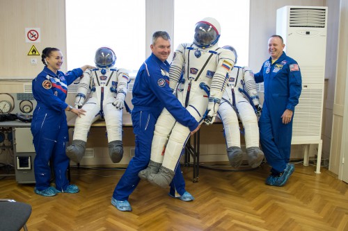 Yelena Serova, Aleksandr Samokutyayev and Barry "Butch" Wilmore share a light moment with their Sokol ("Falcon") launch and entry suits. Photo Credit: NASA