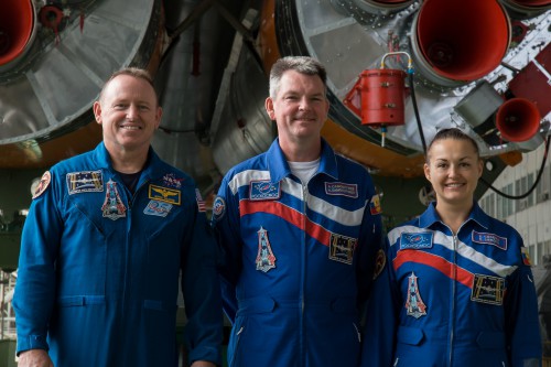 The Soyuz TMA-14M crew (from left) Barry "Butch" Wilmore, Aleksandr Samokutyayev and Yelena Serova pose before the base of their launch vehicle at Baikonur. The trio will spend 168 days in space, forming the second half of Expedition 41 and the core of Expedition 42. Photo Credit: NASA