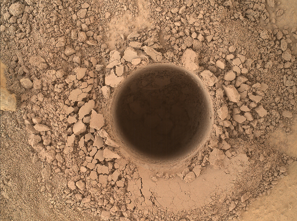 This image from the Mars Hand Lens Imager (MAHLI) camera on NASA's Curiosity Mars rover shows the first sample-collection hole drilled in Mount Sharp, the layered mountain that is the science destination of the rover's extended mission.  Credit: NASA/JPL-Caltech/MSSS