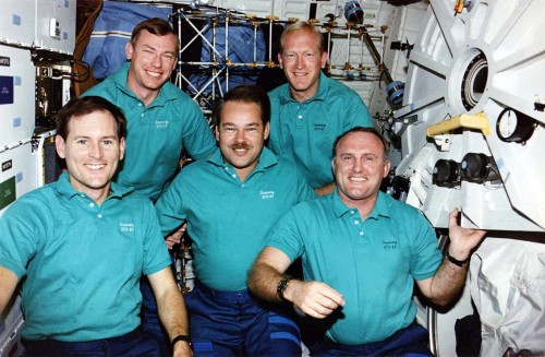 Backdropped by the truss of the Middeck Zero-Gravity Dynamics Experiment (MODE), the STS-48 crew celebrates a successful mission. From left to right are Ken Reightler, Mark Brown, John Creighton, Sam Gemar and Jim Buchli. Photo Credit: NASA