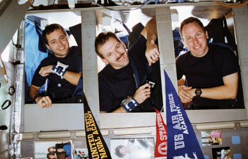 Blue Shift crewmen (from left) Dan Bursch, Steve Smith and Tom Jones peer out of their sleeping stations, just prior to bedtime. STS-68 operated a dual-shift system to monitor the SRL-2 payload around-the-clock. Photo Credit: NASA