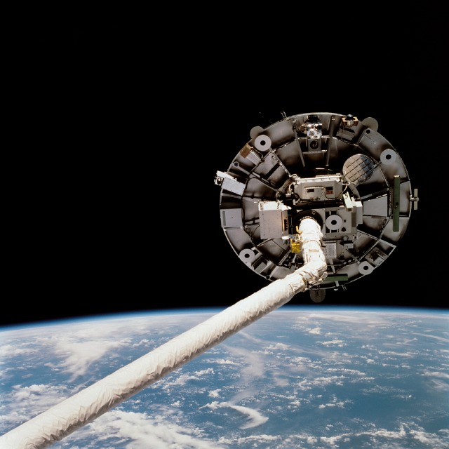 The Wake Shield Facility is pictured on the end of Endeavour's mechanical arm. Photo Credit: NASA
