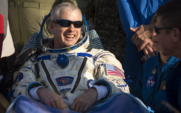 Expedition 40 Commander Steve Swanson grins for well-wishers after the safe return to Earth of Soyuz TMA-12M. Photo Credit: NASA