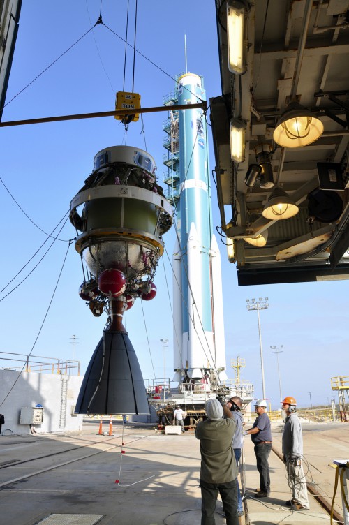 The second stage of the Delta II rocket for NASA's SMAP mission is attached to a crane for its lift into the mobile service tower at Space Launch Complex 2 on Vandenberg Air Force Base in California. Image Credit: NASA