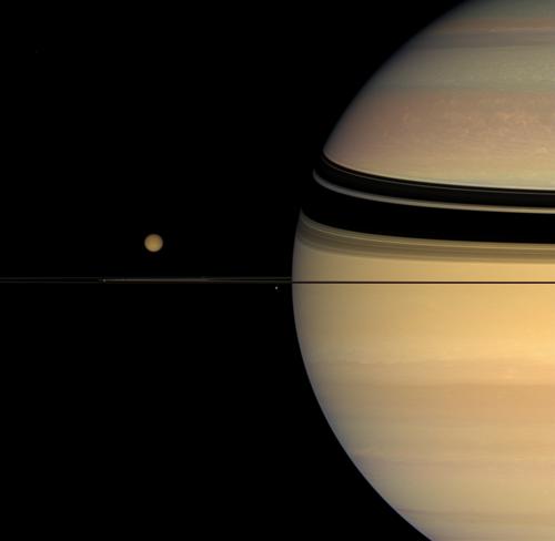 View from Cassini of Saturn with moons Titan (largest), Janus (near tip of rings) and Mimas (just below rings, near edge of disk of Saturn). Image Credit: NASA/JPL/Space Science Institute