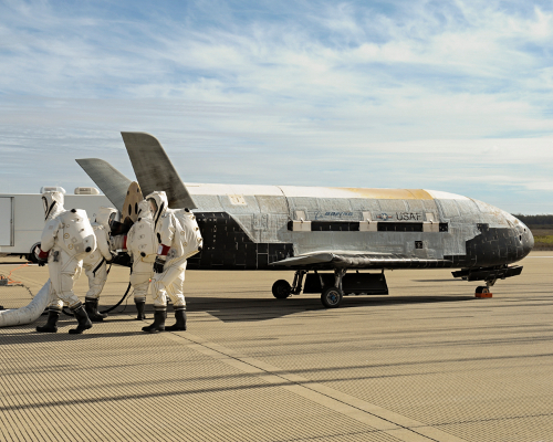 Recovery crew members process the X-37B Orbital Test Vehicle at Vandenberg Air Force Base after completing 674 days in space. A total of three X-37B missions have been completed, totaling 1,367 days on orbit. Photo Credit: Boeing