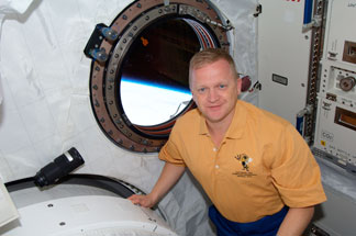 Eric Boe at the window of Japan's Kibo laboratory module, with Earth's limb clearly visible. Photo Credit: NASA