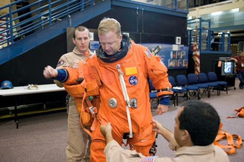 Eric Boe dons a training version of his orange shuttle launch and entry suit during preparations for STS-126. Photo Credit: NASA