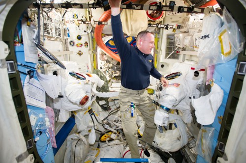 Barry "Butch" Wilmore performs maintenance on U.S. Extravehicular Mobility Units (EMUs) in the Quest airlock. Photo Credit: NASA
