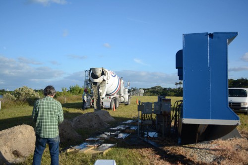 Workers pour concrete for the foundation of the press site countdown clock at KSC. Photo Credit: Lane Hermann 