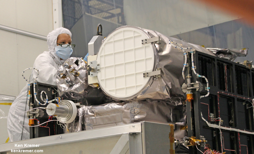 Technician works on NASA Earth science instruments and Earth imaging EPIC camera (white circle) housed on NOAA/NASA Deep Space Climate Observatory (DSCOVR) inside NASA Goddard Space Flight Center clean room in November 2014. Probe is set for January 2015 launch. Credit: Ken Kremer - kenkremer.com