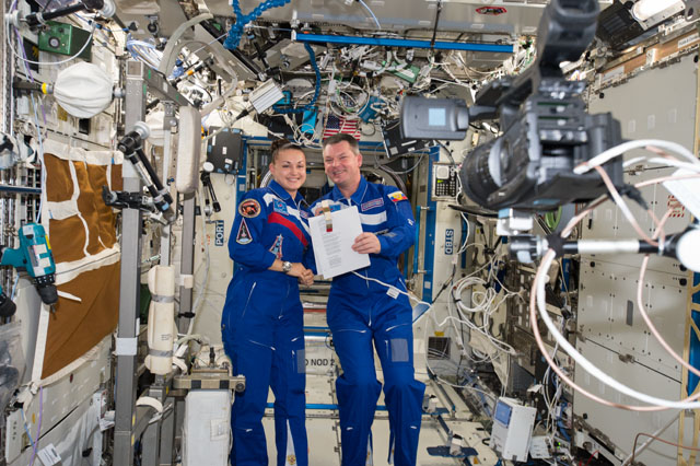 Cosmonauts Elena Serova and Alexander Samokutyaev, both Expedition 42 flight engineers, pose for a portrait inside the International Space Station. Photo Credit: NASA